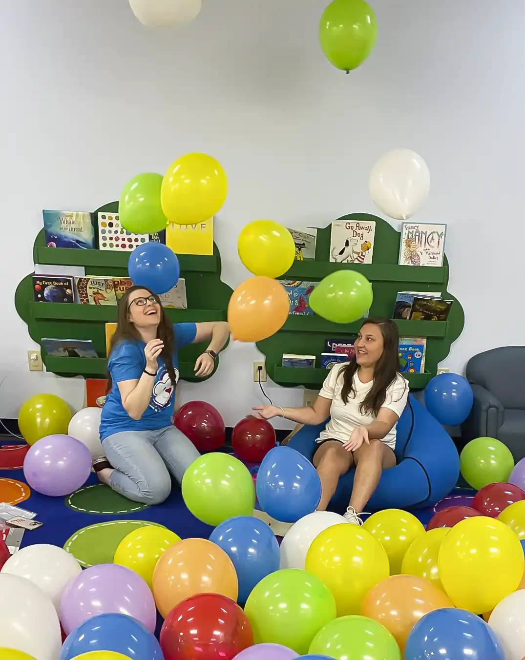 Jillian Long and McKenzie Williams playing with balloons in Jeremiah's Place play area